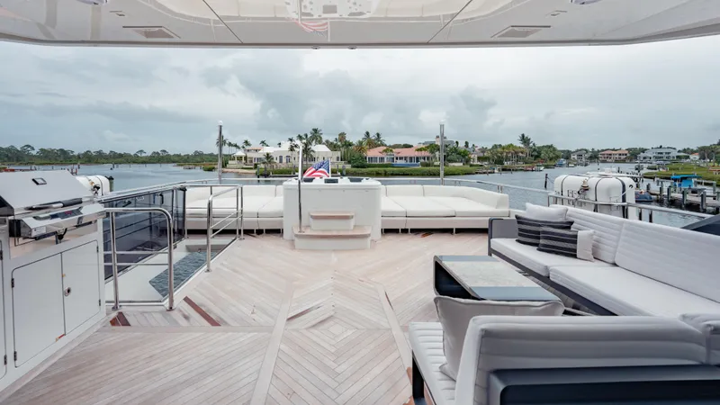 Pinch Me Yacht Photos Pics Luxurious Ocean Alexander 28R yacht deck with elegant seating and scenic waterfront view.