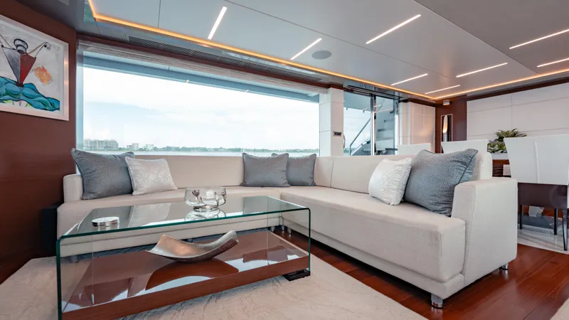 Pinch Me Yacht Photos Pics Luxurious interior of 2021 Ocean Alexander 28R yacht with modern sofa and glass table.