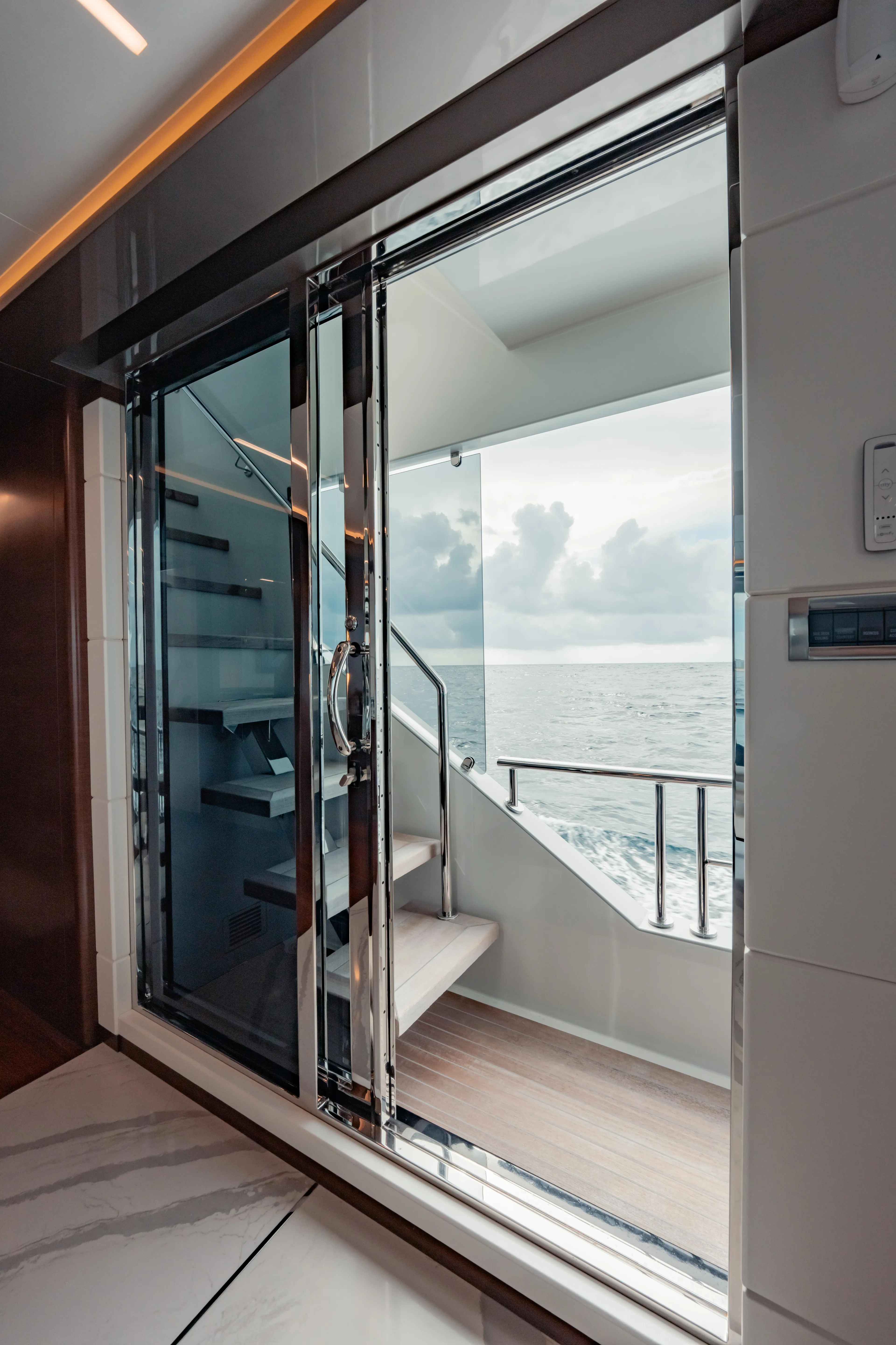 Pinch Me Yacht Photos Pics Luxurious Ocean Alexander 28R yacht interior with ocean view, featuring sleek design and modern staircase.