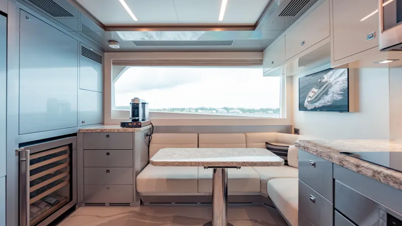 Pinch Me Yacht Photos Pics Luxurious interior of 2021 Ocean Alexander 28R yacht with modern kitchen and seating area.