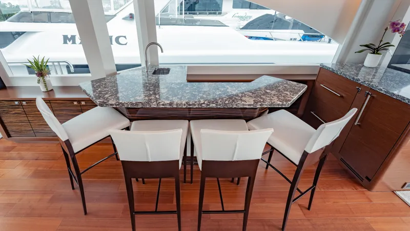 Pinch Me Yacht Photos Pics Luxurious interior of 2021 Ocean Alexander 28R yacht with elegant bar and seating area.