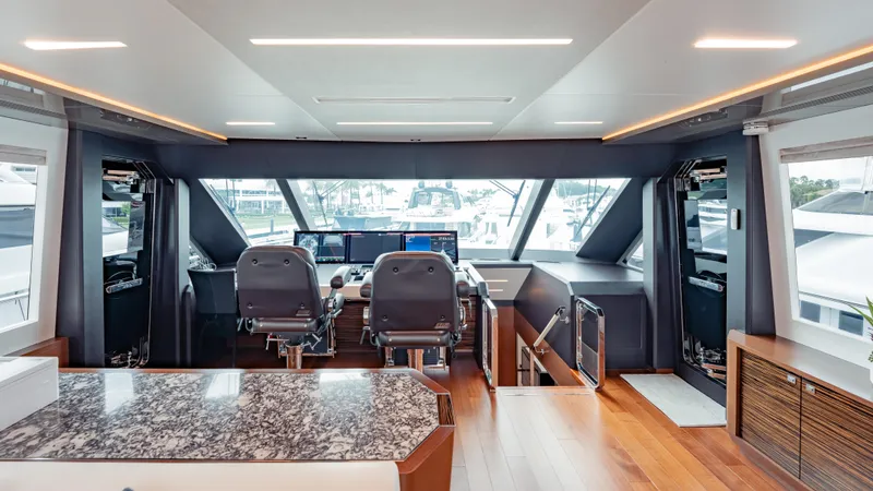 Pinch Me Yacht Photos Pics Luxurious helm of 2021 Ocean Alexander 28R yacht with modern controls and panoramic windows.