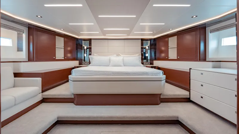 Pinch Me Yacht Photos Pics Luxurious bedroom interior of 2021 Ocean Alexander 28R yacht with modern design and elegant furnishings.