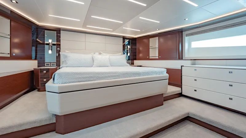 Pinch Me Yacht Photos Pics Luxurious bedroom interior of 2021 Ocean Alexander 28R yacht with modern design elements.