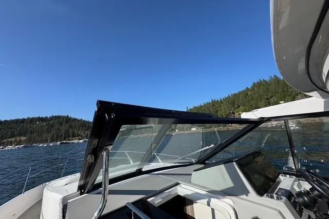  Yacht Photos Pics 2021 Regal 36 Grande Coupe on scenic lake with forested shoreline.