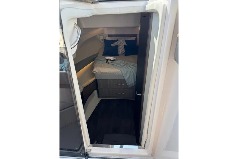  Yacht Photos Pics Interior cabin of 2021 Regal 36 Grande Coupe with cozy bed and nautical decor.