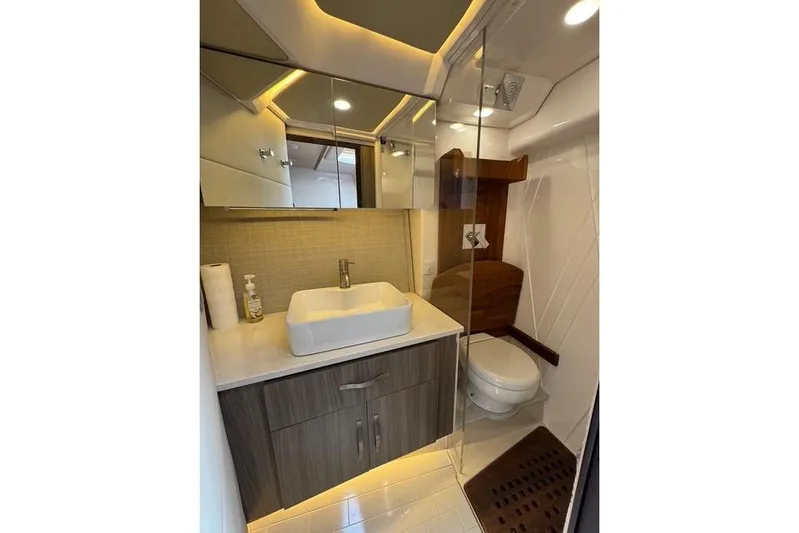  Yacht Photos Pics Luxurious bathroom in 2021 Regal 36 Grande Coupe yacht with modern fixtures and elegant design.