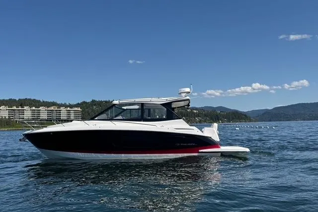  Yacht Photos Pics 2021 Regal 36 Grande Coupe on serene lake with mountain backdrop.