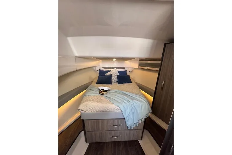  Yacht Photos Pics Luxurious cabin interior of 2021 Regal 36 Grande Coupe with cozy bedding and ambient lighting.