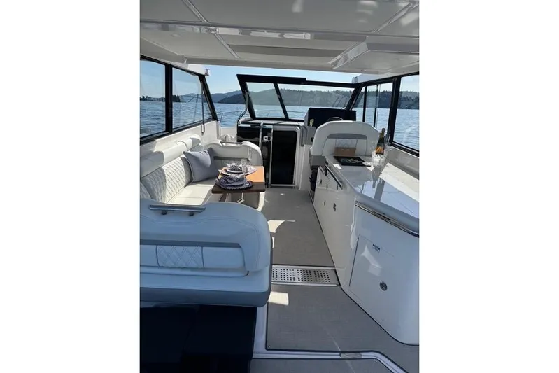  Yacht Photos Pics Interior of 2021 Regal 36 Grande Coupe yacht with elegant seating and dining area.