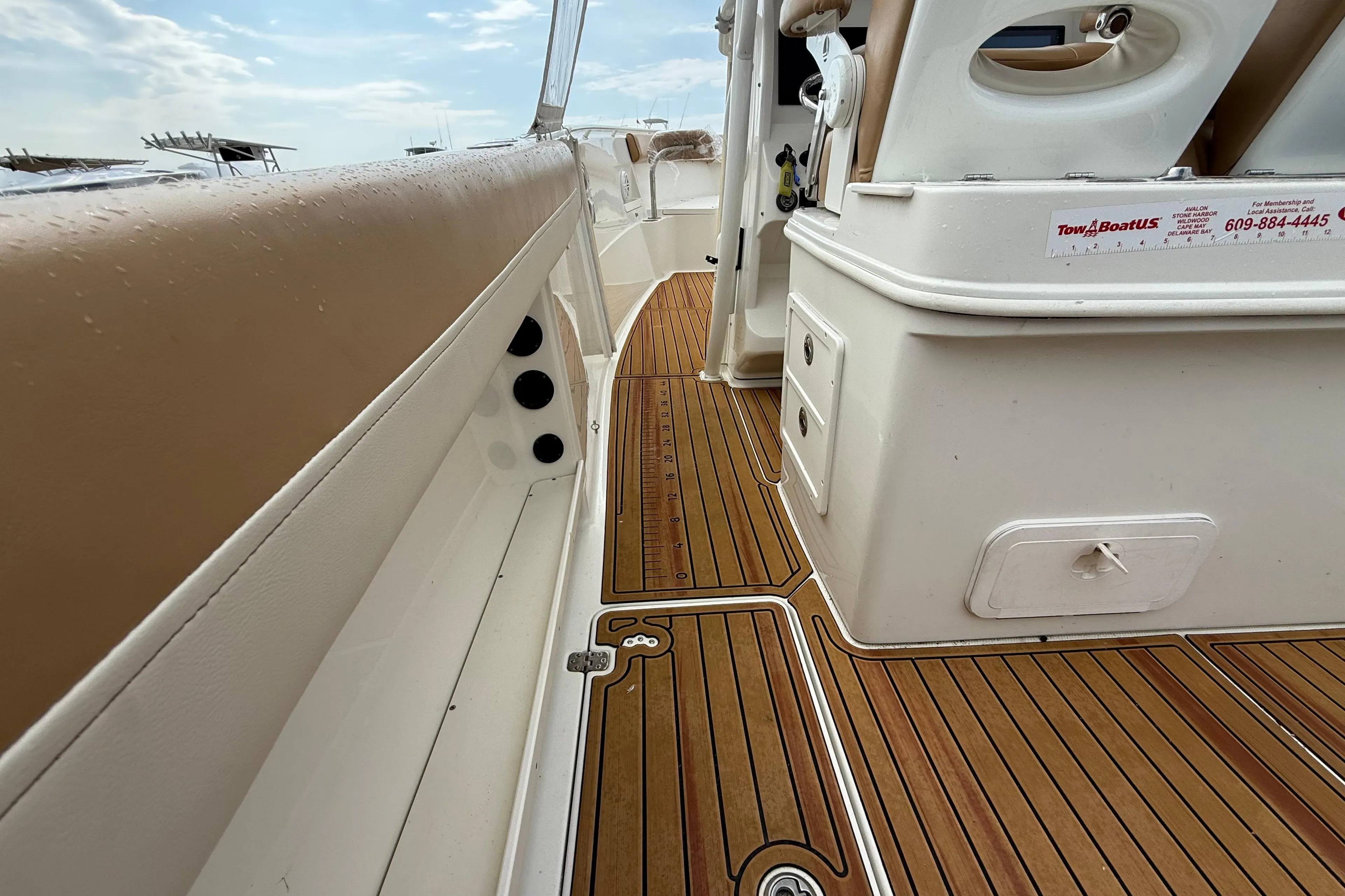 2015 Sailfish 2860 CC boat interior with teak flooring and cushioned seating.