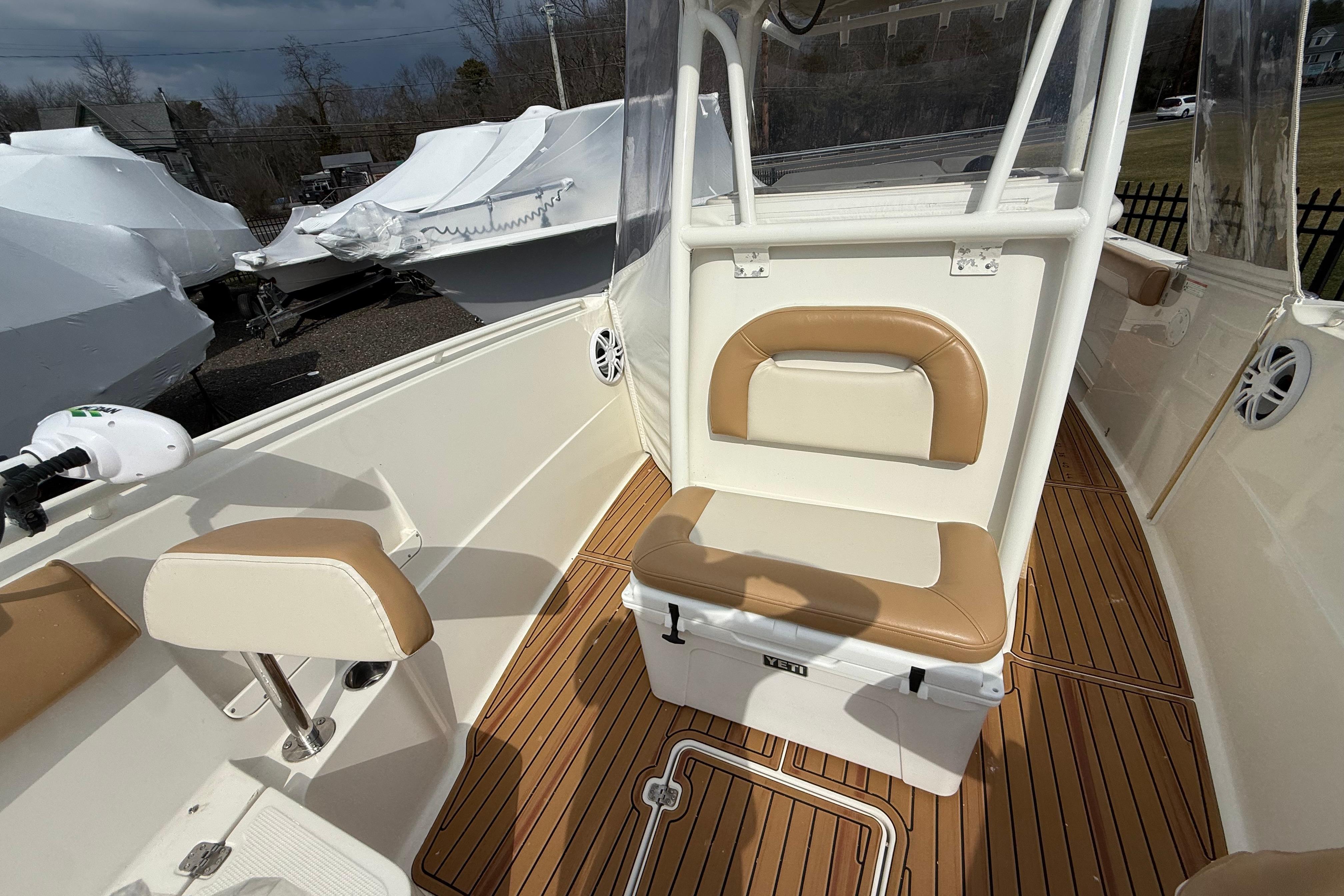 2015 Sailfish 2860 CC boat interior with tan seating and wood-style flooring.