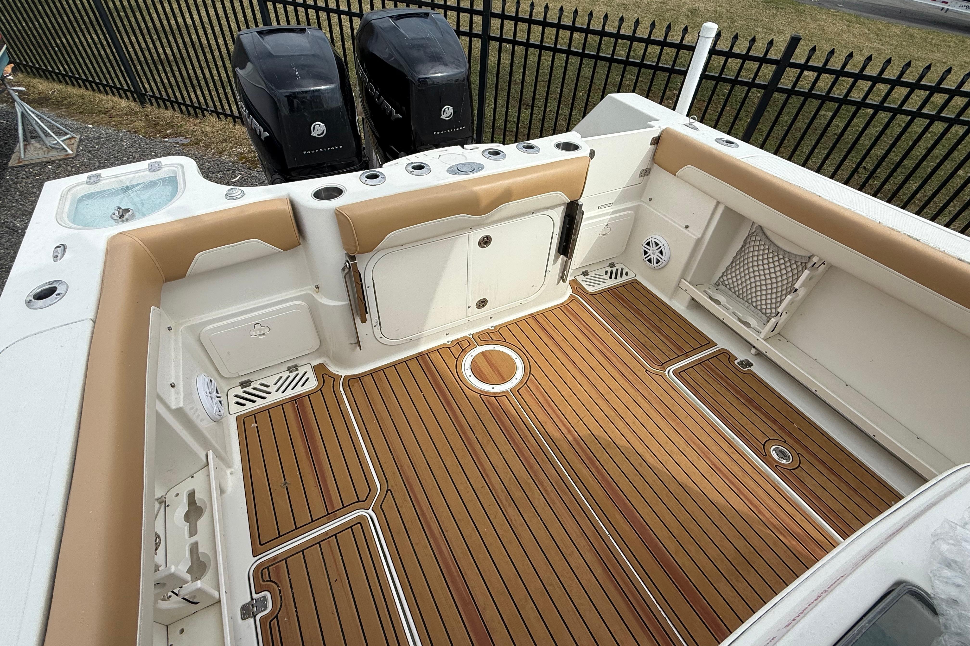 2015 Sailfish 2860 CC boat interior with teak flooring and dual Mercury engines.