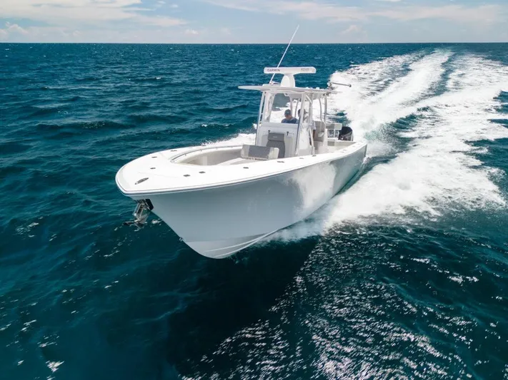  Yacht Photos Pics 2026 Front Runner 33 Center Console boat cruising on open ocean waters.
