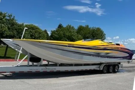  Yacht Photos Pics 2008 Nor-Tech 3600 Supercat powerboat on trailer, vibrant yellow and purple design, parked outdoors.