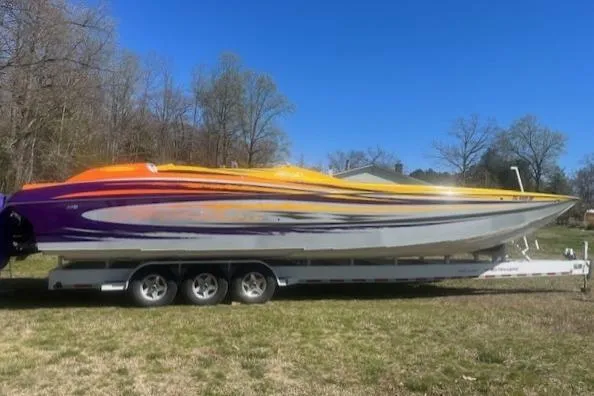  Yacht Photos Pics 2008 Nor-Tech 3600 Supercat boat with vibrant orange and purple design on a trailer.