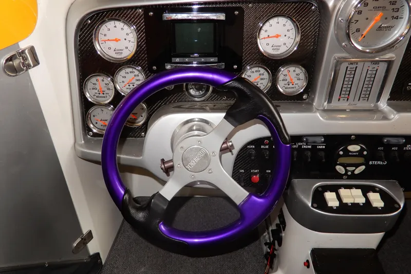  Yacht Photos Pics Dashboard of a 2008 Nor-Tech 3600 Supercat with purple steering wheel and gauges.