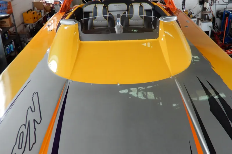  Yacht Photos Pics 2008 Nor-Tech 3600 Supercat with vibrant yellow and gray design in a garage setting.