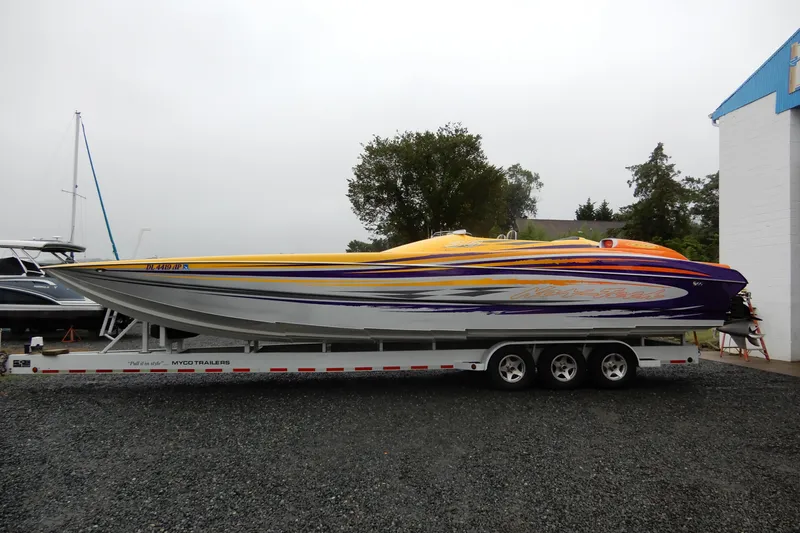  Yacht Photos Pics 2008 Nor-Tech 3600 Supercat powerboat on trailer, vibrant yellow and purple design.