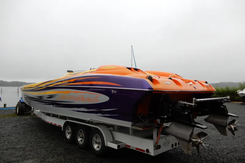  Yacht Photos Pics 2008 Nor-Tech 3600 Supercat powerboat with vibrant orange and purple design on a trailer.