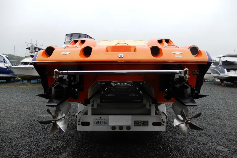  Yacht Photos Pics 2008 Nor-Tech 3600 Supercat in vibrant orange, rear view with dual propellers.