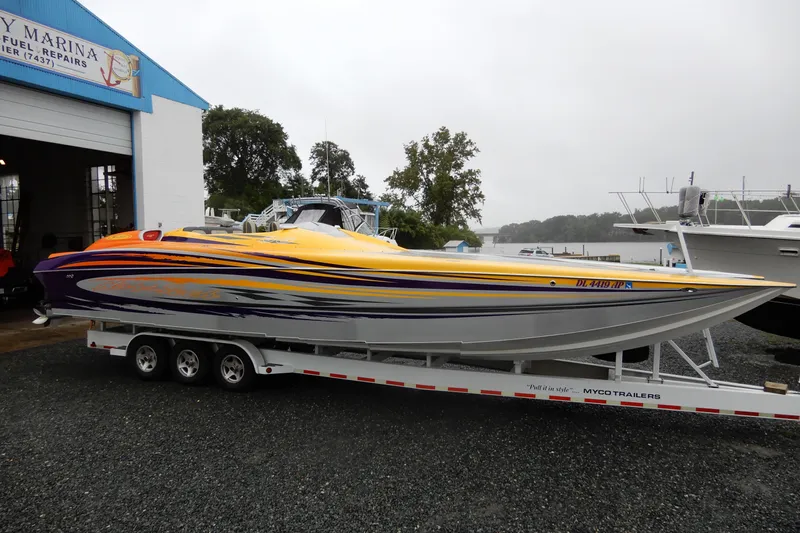  Yacht Photos Pics 2008 Nor-Tech 3600 Supercat powerboat on trailer, vibrant yellow and purple design.