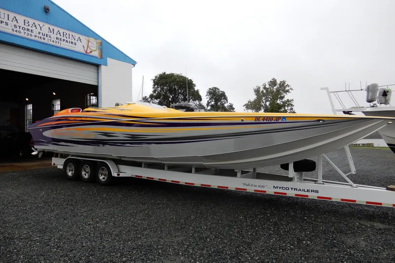  Yacht Photos Pics 2008 Nor-Tech 3600 Supercat boat on trailer at marina, vibrant yellow and purple design.