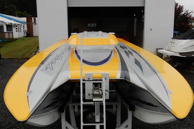  Yacht Photos Pics 2008 Nor-Tech 3600 Supercat powerboat with vibrant yellow and gray design in a garage setting.