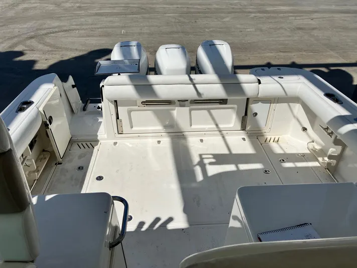  Yacht Photos Pics 2009 Boston Whaler 345 Conquest boat deck with seating and storage compartments.