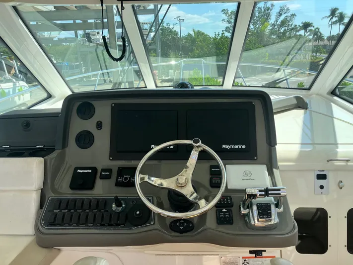  Yacht Photos Pics 2009 Boston Whaler 345 Conquest helm with Raymarine electronics and steering wheel.