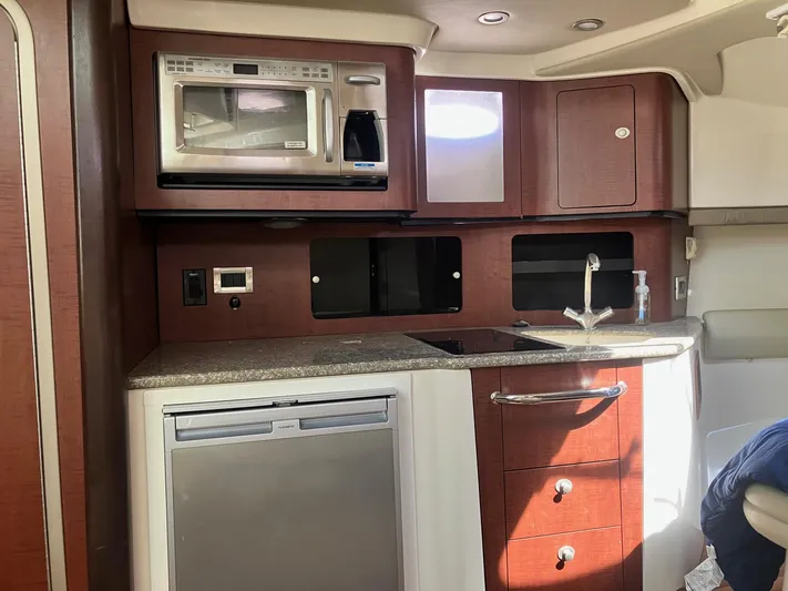  Yacht Photos Pics 2009 Boston Whaler 345 Conquest kitchen with microwave, sink, and fridge.