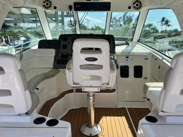  Yacht Photos Pics 2009 Boston Whaler 345 Conquest helm with white seating and wood flooring.