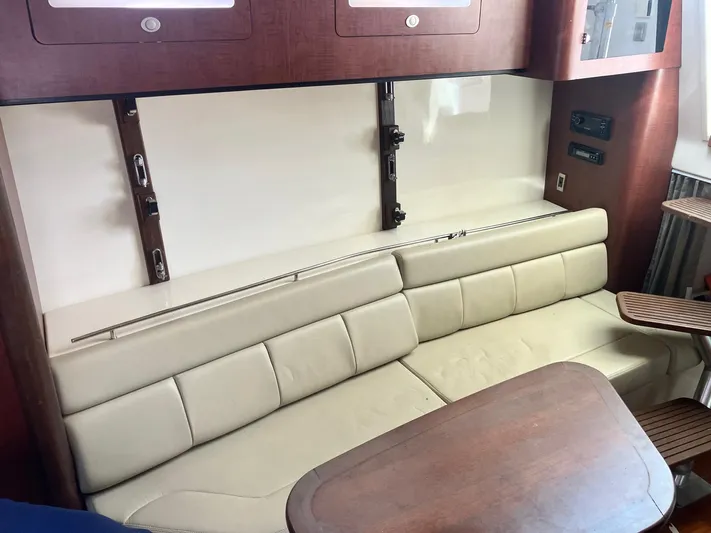  Yacht Photos Pics 2009 Boston Whaler 345 Conquest interior with beige seating and wooden accents.