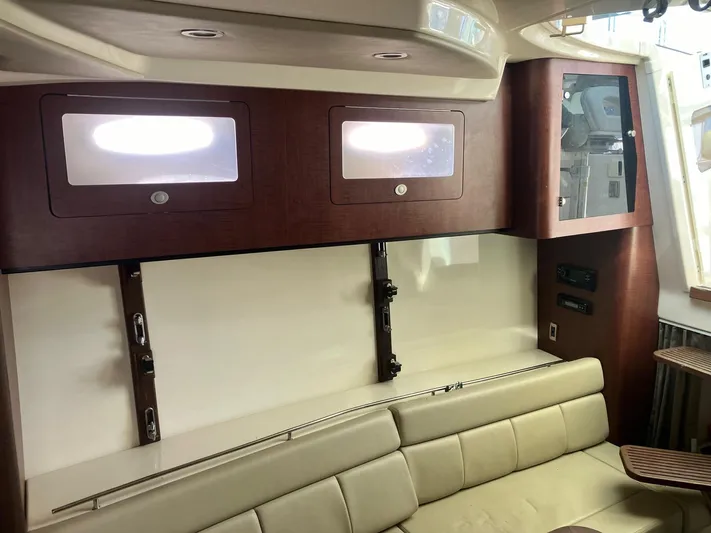  Yacht Photos Pics Interior of 2009 Boston Whaler 345 Conquest, featuring leather seating and wooden cabinetry.