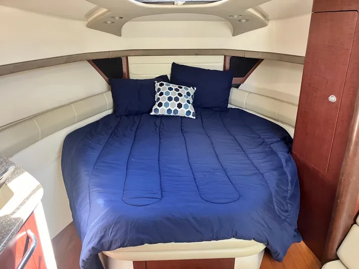  Yacht Photos Pics Luxurious cabin interior of 2009 Boston Whaler 345 Conquest with cozy bed and pillows.