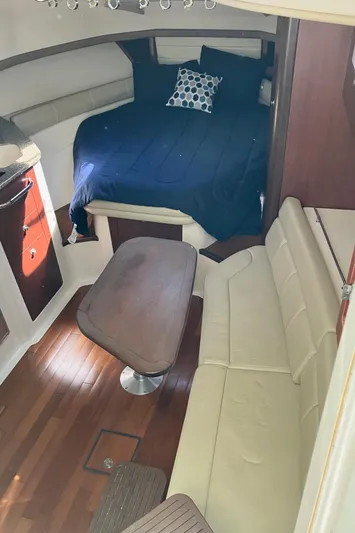  Yacht Photos Pics 2009 Boston Whaler 345 Conquest cabin interior with bed, table, and seating.