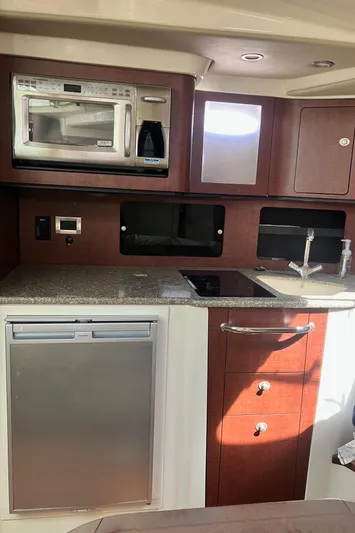  Yacht Photos Pics 2009 Boston Whaler 345 Conquest kitchen with microwave, sink, and fridge.