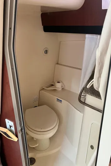  Yacht Photos Pics 2009 Boston Whaler 345 Conquest boat bathroom interior with toilet and storage.
