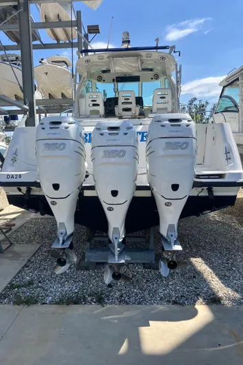  Yacht Photos Pics 2009 Boston Whaler 345 Conquest with triple outboard engines, docked in a marina.