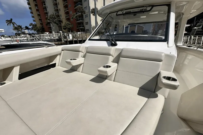  Yacht Photos Pics 2019 Boston Whaler 350 Realm boat interior with beige seating and cup holders.