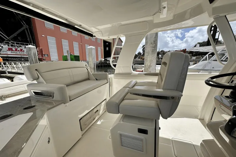  Yacht Photos Pics 2019 Boston Whaler 350 Realm interior with plush seating and modern helm.