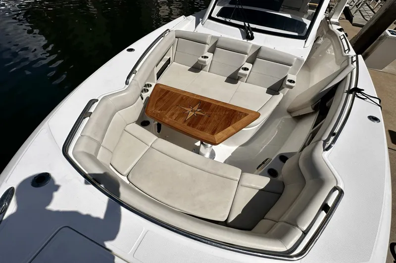  Yacht Photos Pics 2019 Boston Whaler 350 Realm boat with spacious seating and elegant wooden table.
