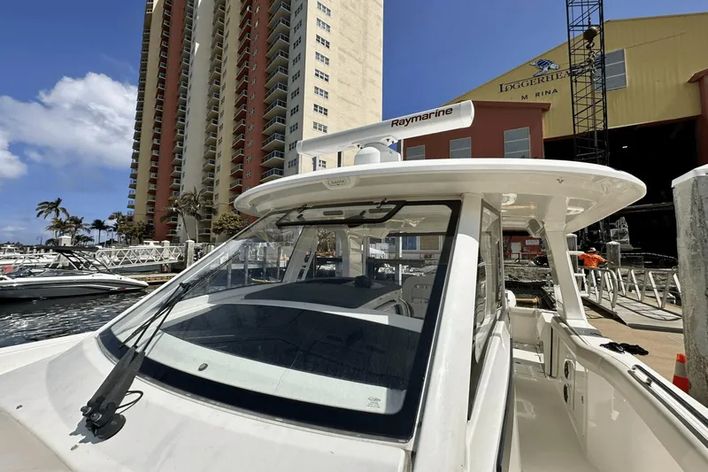  Yacht Photos Pics 2019 Boston Whaler 350 Realm docked near tall buildings and marina.