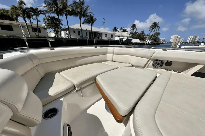  Yacht Photos Pics Luxurious seating area on a 2019 Boston Whaler 350 Realm boat, with palm trees in the background.