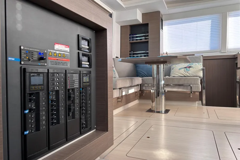  Yacht Photos Pics Modern interior of 2022 Leopard 42 yacht with control panel and seating area.