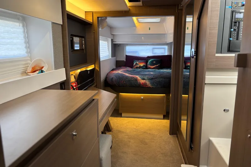  Yacht Photos Pics Luxurious interior of 2022 Leopard 42 yacht with cozy bedroom and modern furnishings.