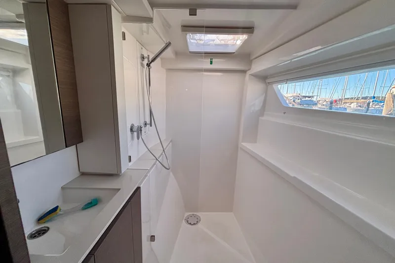  Yacht Photos Pics Modern bathroom interior of 2022 Leopard 42 yacht with shower and window view.