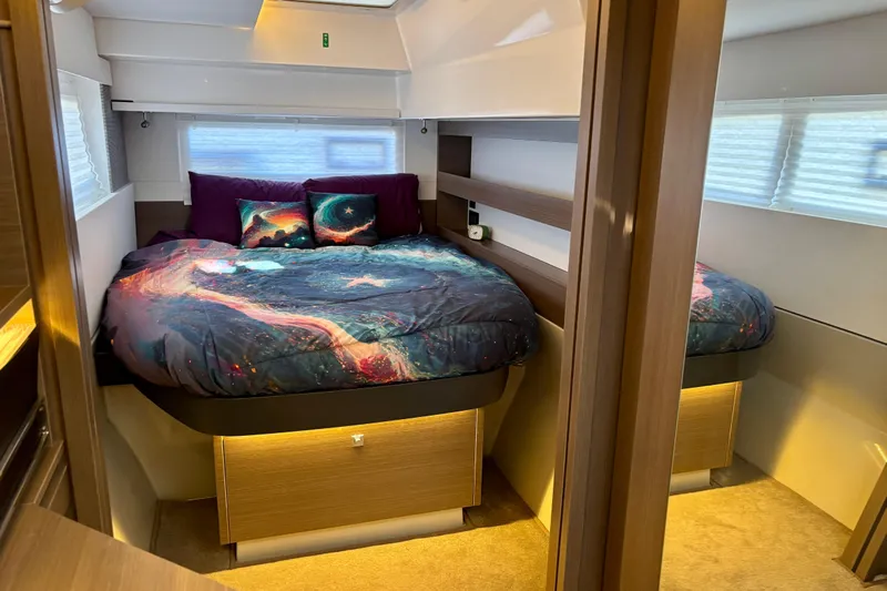  Yacht Photos Pics Luxurious bedroom interior of 2022 Leopard 42 yacht with cosmic-themed bedding.