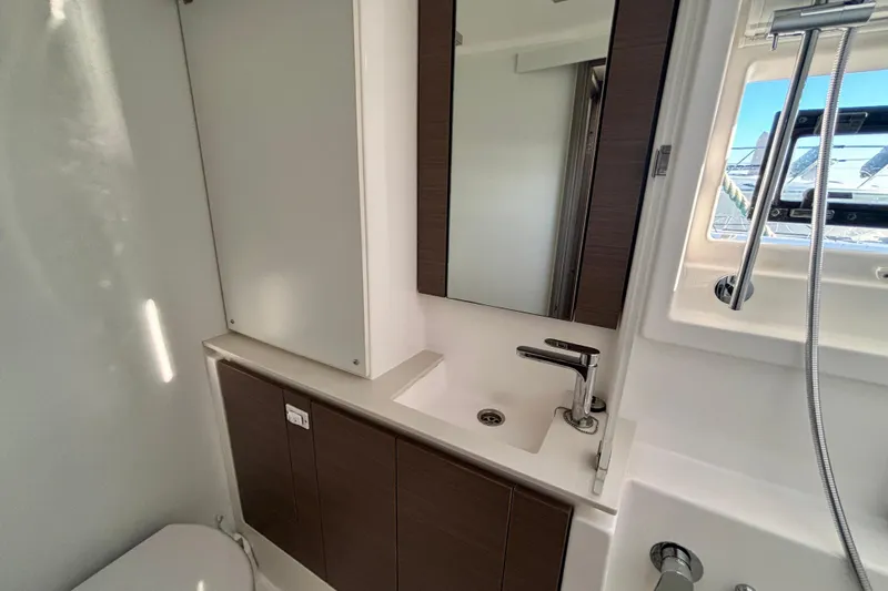  Yacht Photos Pics Modern bathroom interior of 2022 Leopard 42 yacht, featuring sleek sink and mirror design.