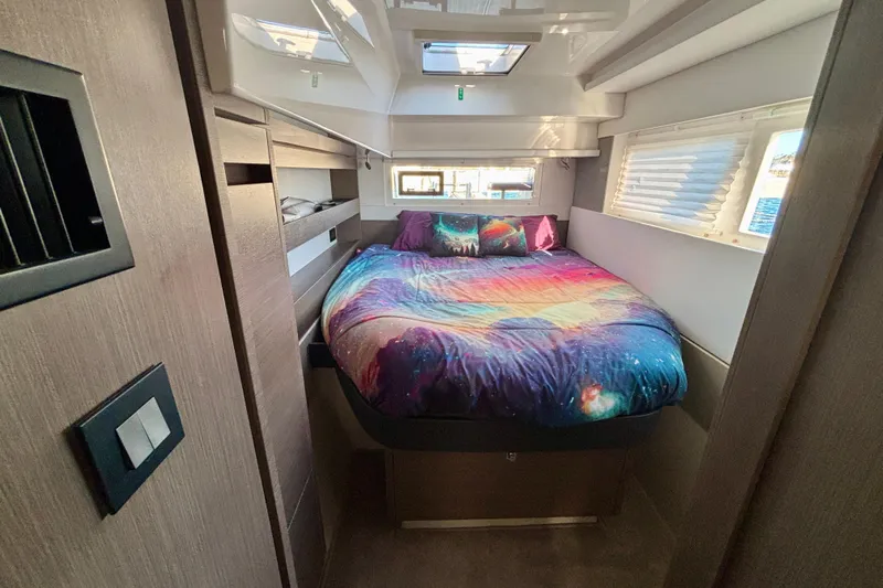  Yacht Photos Pics Cozy bedroom in 2022 Leopard 42 yacht with colorful galaxy-themed bedding.